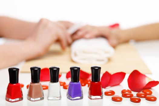 Young woman is getting manicure in a beauty salon