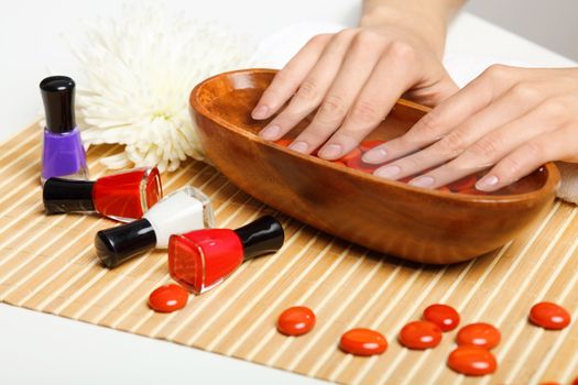 Young woman is getting manicure in a beauty salon