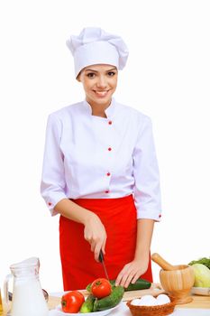 Young cook preparing food wearing a red apron