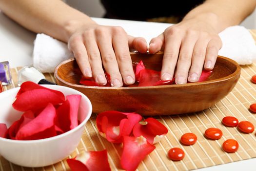 Young woman is getting manicure in a beauty salon