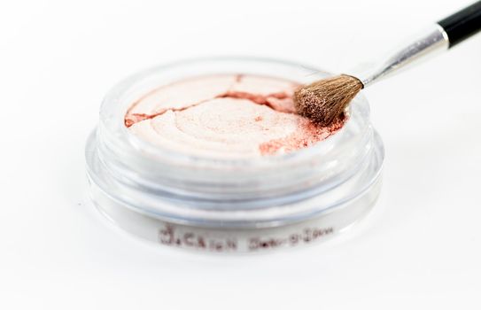 Makeup powder in sphere box with brush on white background isolate