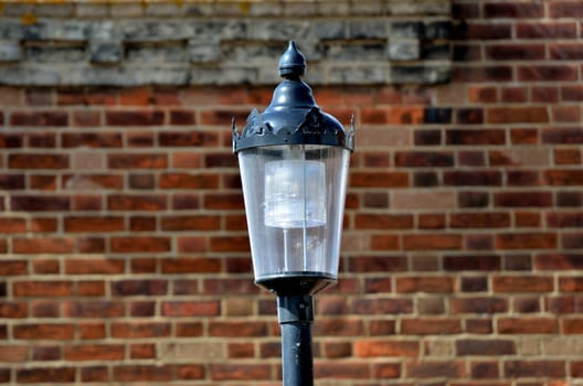 Black Lamp against Brick Background