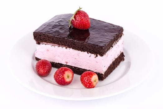 Strawberries and chocolate cake on the plate.