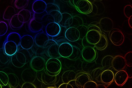 Abstract Neon rainbow colored rings on a black background