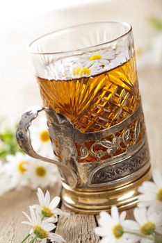 cup of herbal tea with chamomile flowers 