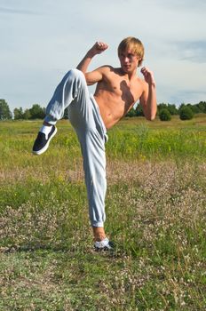 Karate guy shows reception on grass