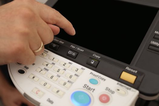 details Finger pressing of keyboard buttons of the laser copier