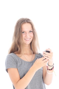 Happy smiling young girl reading a text message on her mobile phone isolated on white 