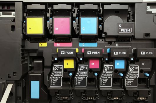 close-up shot of a CMYK ink cartridges for laser copier machine 