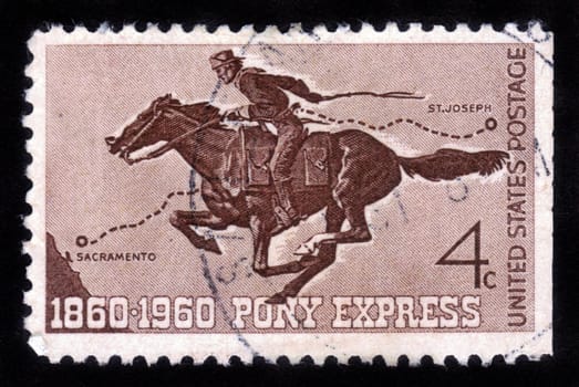 UNITED STATES - CIRCA 1960: A  stamp printed in the United States shows Pony Express Rider, honoring 100 yrs of the Pony Express the first American mail delivery system , circa 1960