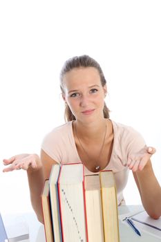 Distraught distressed student indicating a pile of books with her hands as she realises the enormity of her studies at university 