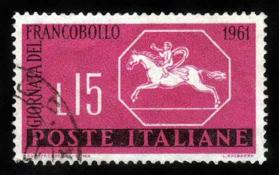 ITALY - CIRCA 1961: A stamp printed in Italy from the " Stamp Day ".depicted a boy on a horse , blowing a postal horns, circa 1961