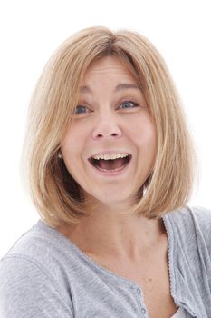 Laughing attractive woman with a surprised expression and her mouth open looking at the viewer, head and shoulders isolated on white