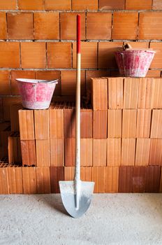 masonry, Bricks, Shovel and buckets in a under construction site.