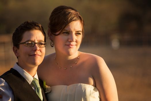 Grinning gay married couple outside after wedding