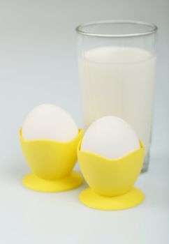 Milk in a glass jar and eggs on the table