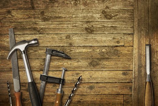 Carpentry hand tools set on old wooden background