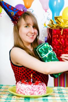Birthday girl. A teenager with a bunch of gift boxes