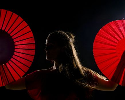 Low key and backlit portrait of a female flamenco dancer