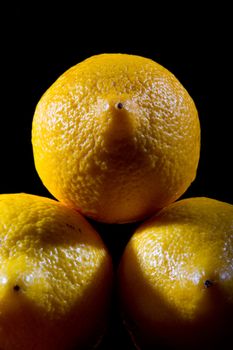 Three Lemons on plack background