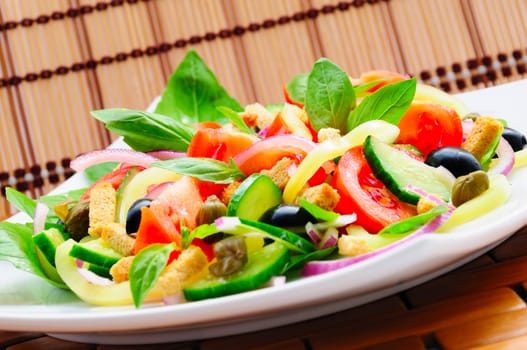 Fresh vegetable salad with basil, capers, olives, marinated with croutons