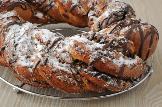 Poppy seed roll, garnished with chocolate and powdered sugar