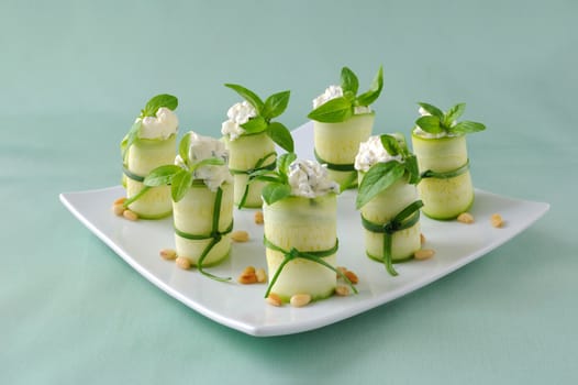 Rolls of zucchini stuffed with ricotta and basil and pine nuts