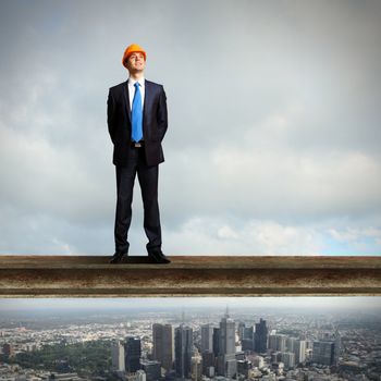 Businessman standing in suit on the construction site