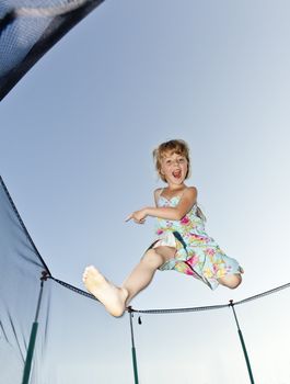 Young Girl Jumping in a trampoline