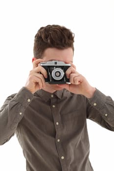 A young adult male on white background with an old film camera