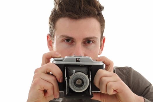 A young adult male on white background with an old film camera