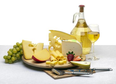 Composition of cheese, grapes, bottles and glasses of wine and strawberries on a wooden round tray on a white tablecloth, isolated on a white background