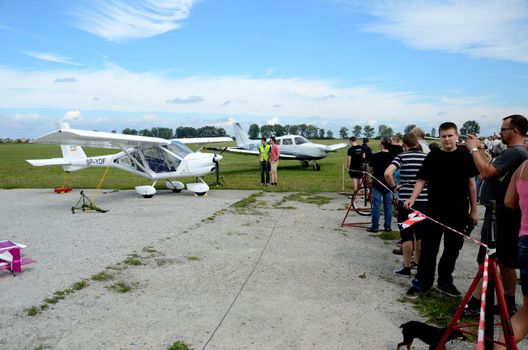 SZYMANOW, POLAND - AUGUST 25: Unidentified group of people admires planes during air show on August 25, 2012 in Szymanow.