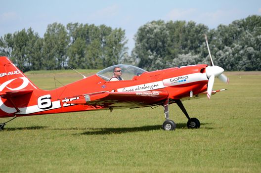 SZYMANOW, POLAND - AUGUST 25: Pilot Tadeusz Kolaszewski takes off for acrobatic show in plane Zlin-50 LS on August 25, 2012 in Szymanow.