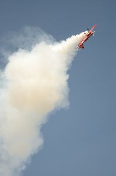 SZYMANOW, POLAND - AUGUST 25: Pilot Tadeusz Kolaszewski performs acrobatic show in plane Zlin-50 LS on August 25, 2012 in Szymanow.