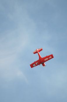 SZYMANOW, POLAND - AUGUST 25: Pilot Tadeusz Kolaszewski performs acrobatic show in plane Zlin-50 LS on August 25, 2012 in Szymanow.