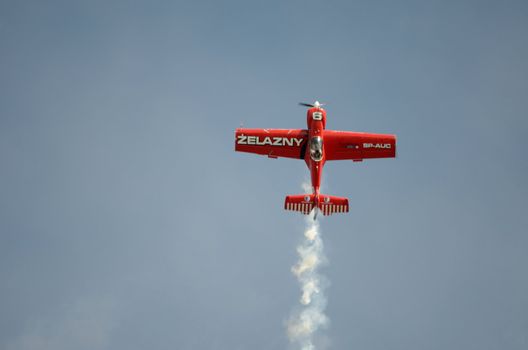 SZYMANOW, POLAND - AUGUST 25: Pilot Tadeusz Kolaszewski performs acrobatic show in plane Zlin-50 LS on August 25, 2012 in Szymanow.