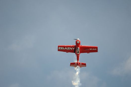 SZYMANOW, POLAND - AUGUST 25: Pilot Tadeusz Kolaszewski performs acrobatic show in plane Zlin-50 LS on August 25, 2012 in Szymanow.