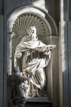 Sculpture in a niche on the wall inside St. Peter's Basilica in Rome, Italy