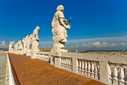 Statues of eleven of the apostles on the top of St. Peter's Basilica facade. Rome, Italy