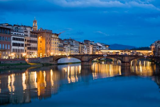 Ancient buildings and old bridge reflecting in River Arno in Florence, Italy
