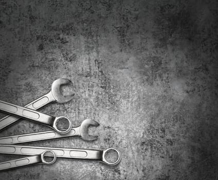 Wrench spanner tools on grunge silver metal background