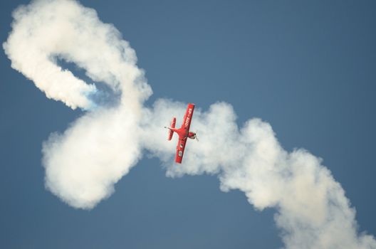 SZYMANOW, POLAND - AUGUST 25: Pilot Tadeusz Kolaszewski performs acrobatic show in plane Zlin-50 LS on August 25, 2012 in Szymanow.
