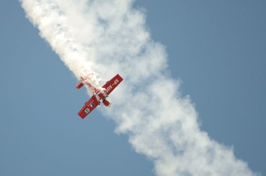 SZYMANOW, POLAND - AUGUST 25: Pilot Tadeusz Kolaszewski performs acrobatic show in plane Zlin-50 LS on August 25, 2012 in Szymanow.