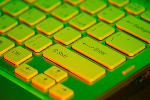 Keyboard modern laptop photographed with the effect of colored illumination