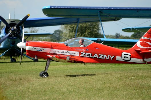 SZYMANOW, POLAND - AUGUST 25: Pilot Tadeusz Kolaszewski lands after the acrobatic show in plane Zlin-50 LS on August 25, 2012 in Szymanow.