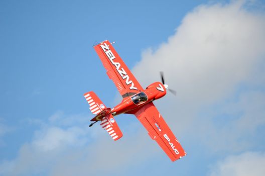 SZYMANOW, POLAND - AUGUST 25: Pilot Piotr Haberland performs acrobatic show in plane Zlin-50 LS on August 25, 2012 in Szymanow.