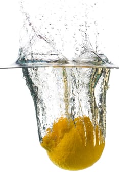 Lemon in a spray of the water on a white background