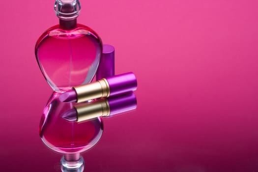 Small still life of bottles of perfume and lipstick