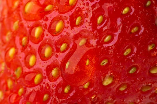 Very close-up of strawberries with drops of dew